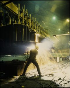 En arbeider sveiser inne på aluminiumsverket til Hydro på Karmøy.